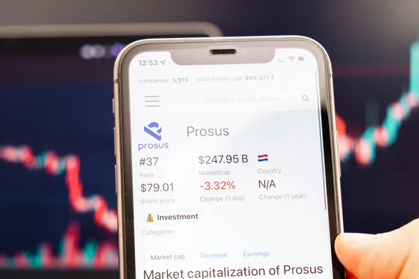Prosus Aktienkurs auf dem Bildschirm des Mobiltelefons in der Hand mit sich ändernden Börsenkursen im Hintergrund, Februar 2022, San Francisco, USA — Stockfoto