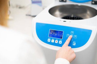 Kadın örnek hazırlama için santrifüj parametrelerini ayarlar. 