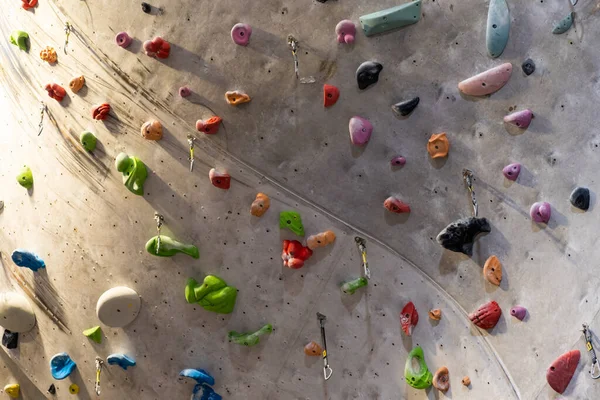Konstgjord bergsklättring vägg med olika färgade grepp — Stockfoto