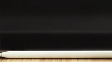 Man opens tablet taking digital pen for using touch screen