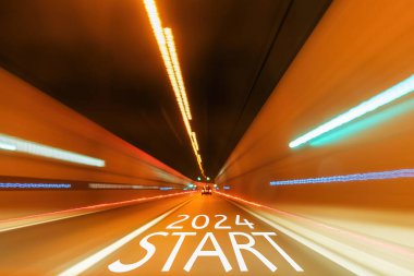 Text Start 2024 the road in the tunnel with blurred light.