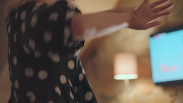 Woman Dances Room Wearing Black Polka Dot Dress Hem Blurry — Vídeo de Stock