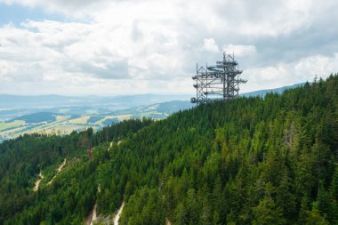 Sky walk observation tower in the forest between mountain hills near Sky Bridge 721 in a sunny summer day, Dolni Morava, Czech Republic. 