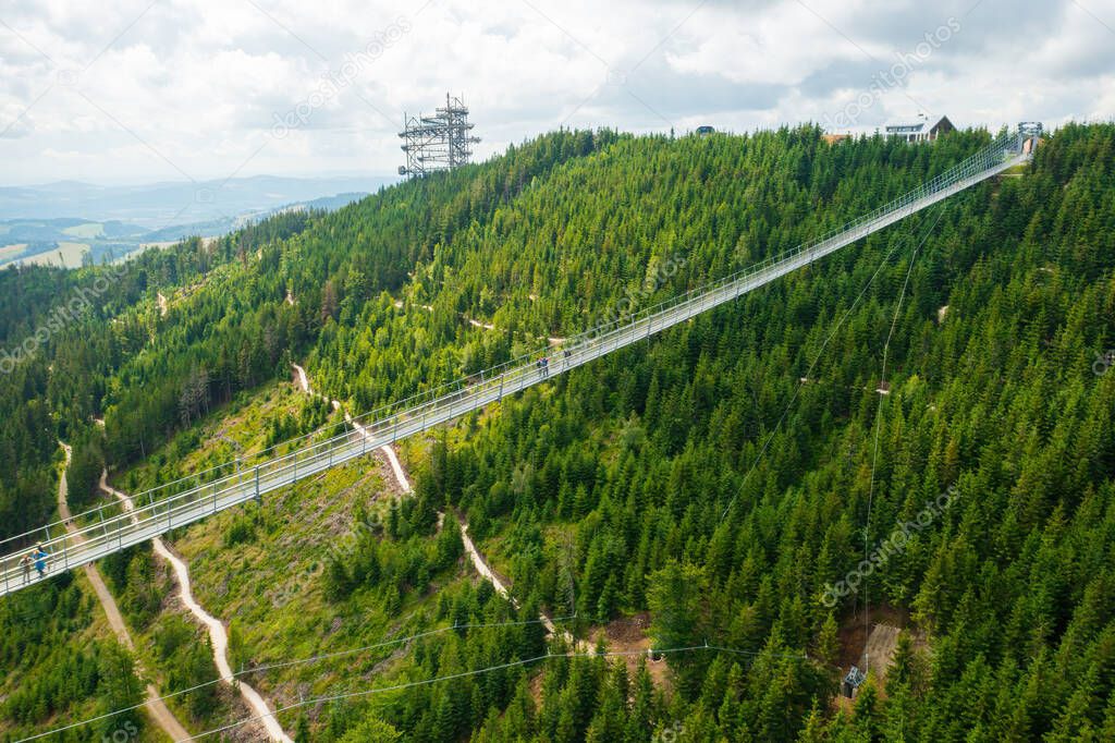 Aerial view of the worlds longest 721 meter suspension footbridge Sky bridge and observation tower the Sky walk in the forest, between mountains, Dolni Morava Ski Resort, Czech Republic. 