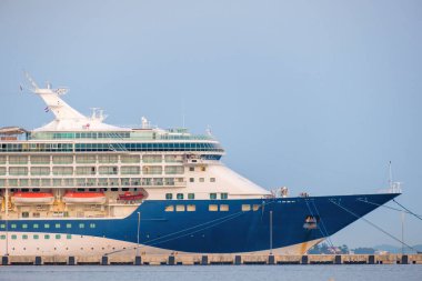 RIJEKA, CROATIA - JULY 10 2022: Passenger ship moored to large berth landing passengers after sea voyage against blue sky. Huge passenger cruise liner moored to long pier closeup on July 10 in Rijeka