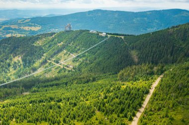 Dünyanın en uzun 721 metrelik asma köprü ve gözlem kulesinin havadan görünüşü. Gökyüzü ormanda yürüyor, dağların arasında, Dolni Morava Kayak Merkezi, Çek Cumhuriyeti. 