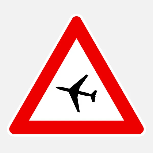 ベクトル危険道路標識前の低飛行航空機 — ストックベクタ