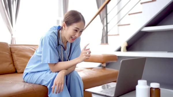 Asian doctor making an online video conference with a patient, tele medical service concept. Female doctor making a medication advise via online podcast or live streaming on social network.