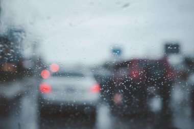 Beautiful texture of rain drop on the windshield glass while driving. Water drop or droplet on glass background.