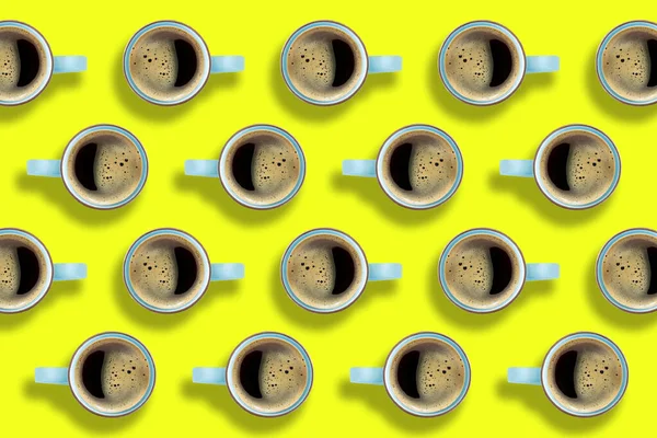 Pattern of coffee cups on bright yellow background. A hot Americano coffee in a cups arranged on yellow background.