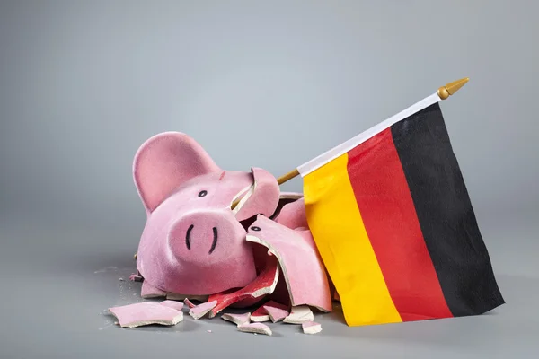 Robbed piggy bank with German flag — Stock Photo, Image