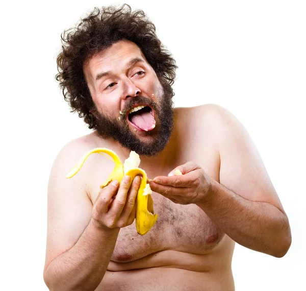 Caveman eating a banana — Stock Photo, Image