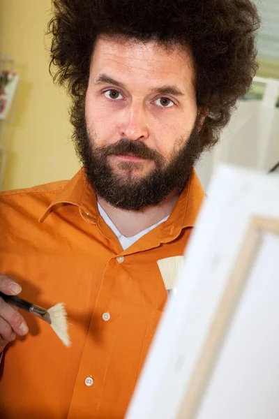 Bearded painter in his studio — Stock Photo, Image