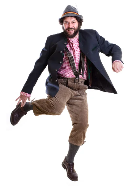 Бородатый баварский мужчина в традиционной одежде, танцующий — стоковое фото