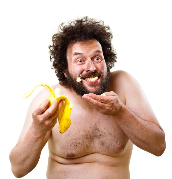Barlanglakó ősember boldog, hogy miután egy banánt enni — Stock Fotó