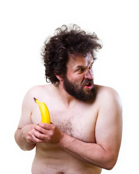 Wild man looking confused at a banana — Stock Photo, Image