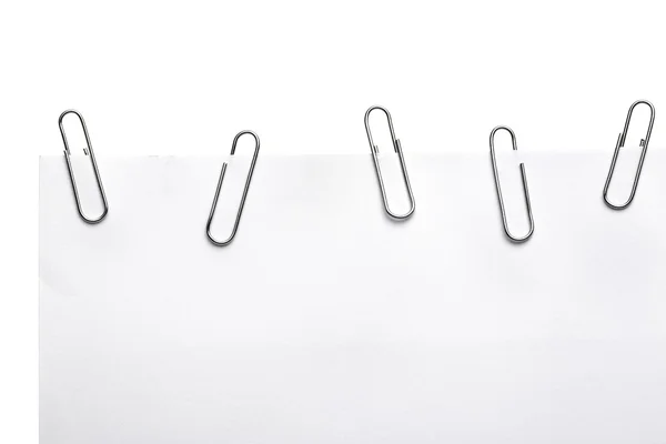 Paper clips on white piece of paper — Stock Photo, Image