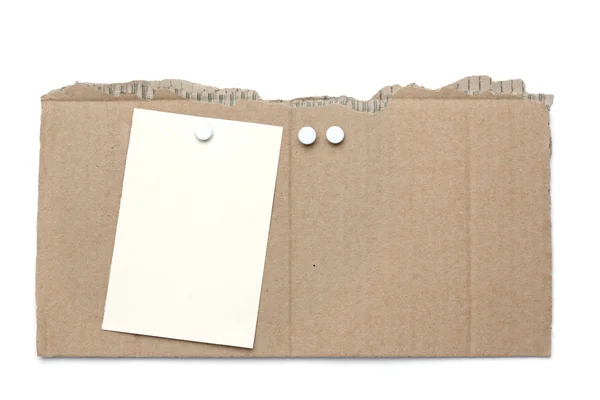 Pieza de cartón con alfileres y nota — Foto de Stock
