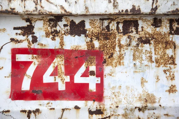 Grungy rusted steel with number 744 Royalty Free Stock Images