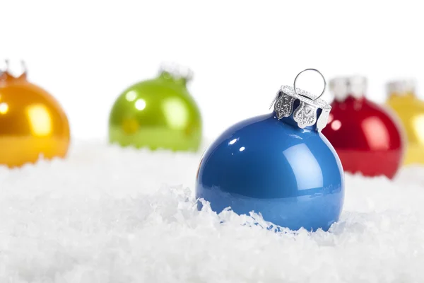 Blue Christmas bauble in decorative snow — Stock Photo, Image