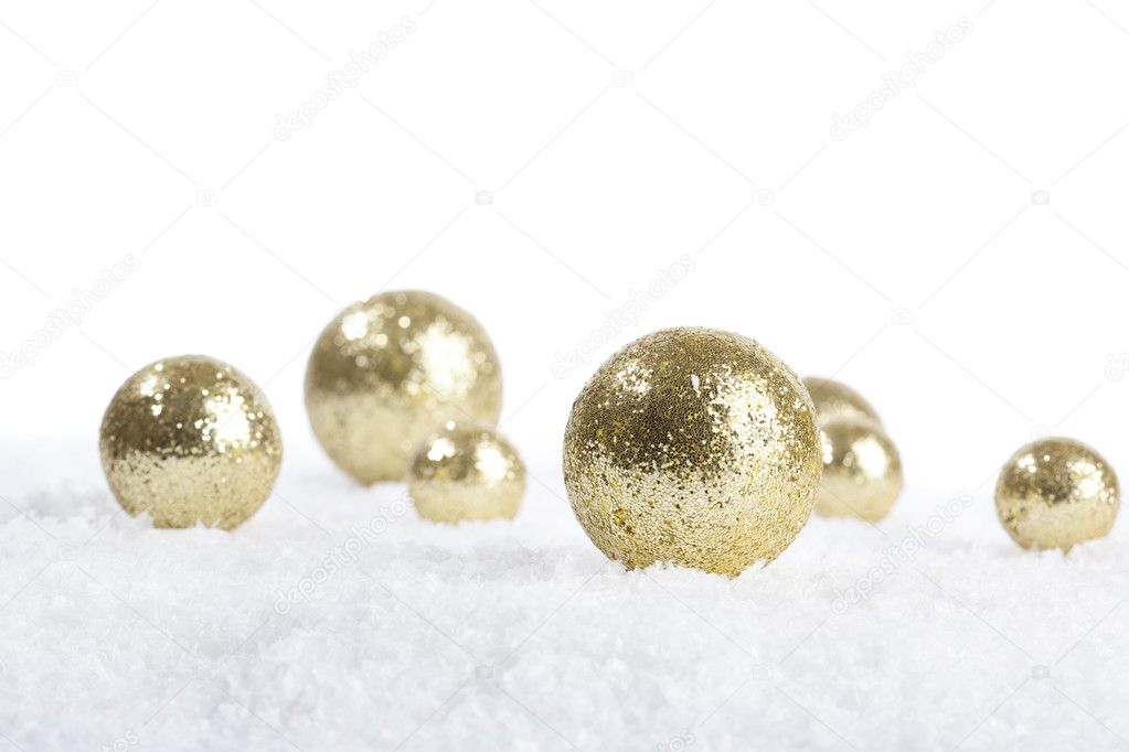 Golden decoration balls for Christmas on snow