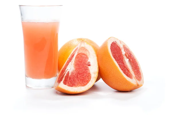 Grapefruit pieces and juice in a glass, isolated on white — Stock Photo, Image