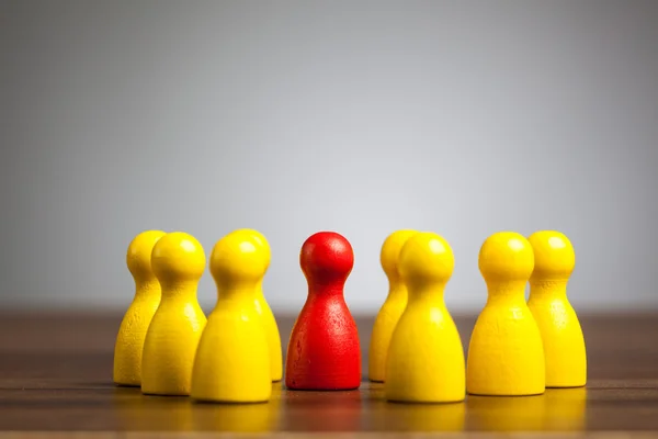 Leader in the center, concept with toy pawn figures — Stock Photo, Image