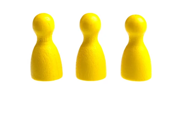 Tres figuras de juego de peón amarillo — Foto de Stock