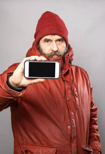 Mature Man Showing Smart Phone Screen Camera Thick Winter Coat — Stock Fotó