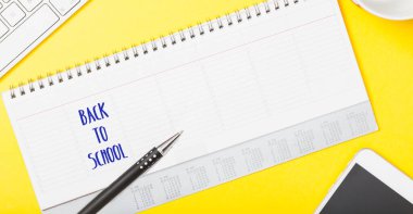 Back to School written in calendare office table flat lay with electronic device as symbol for connectivity