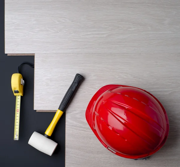 Texture laminate and tools with a red helmet — Stock Photo, Image