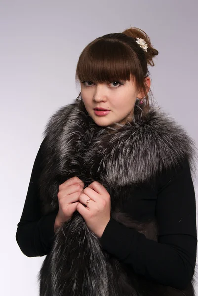 Beautiful girl in a fur cape — Stock Photo, Image