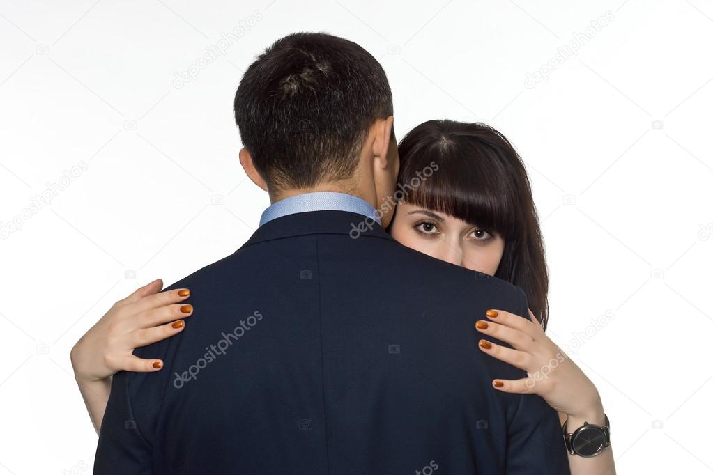girl looking out from behind the backs of men