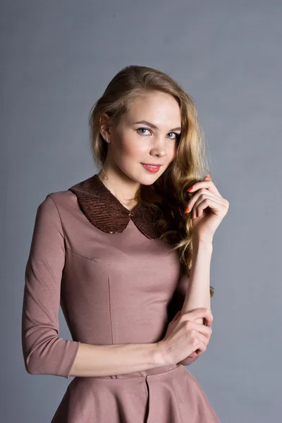 Beautiful young girl in a brown dress — Stock Photo, Image