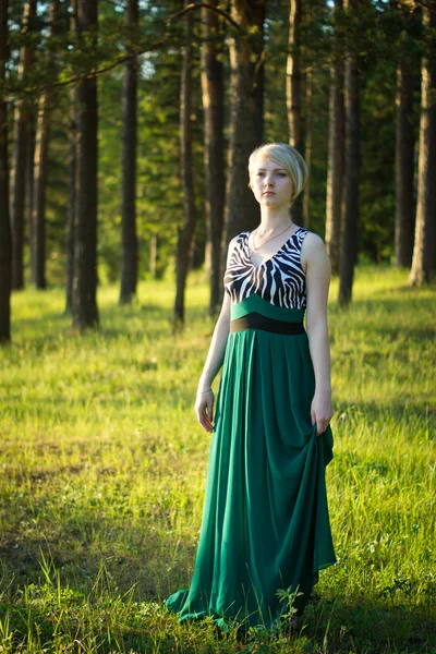 Beautiful girl in a long green dress — Stock Photo, Image