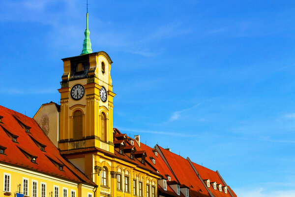 Bright photo of Old buildings in Czech. Blue beautiful sky and old houses with red roofs