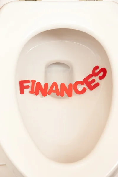 Bathroom toilet with the inscription finances — Stock Photo, Image