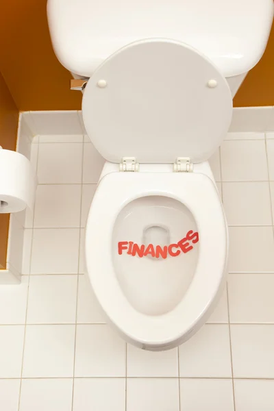 Bathroom toilet with the inscription finances — Stock Photo, Image