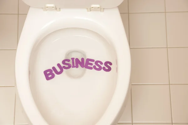 Bathroom toilet with the inscription business — Stock Photo, Image