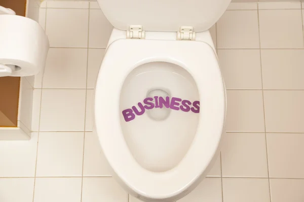 Bathroom toilet with the inscription business — Stock Photo, Image