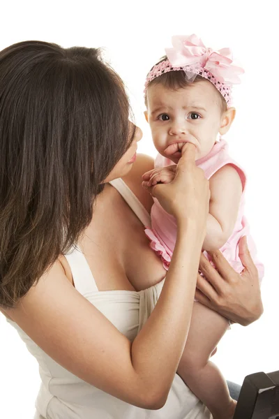 Little baby girl chewing mother's finger — Stock Photo, Image