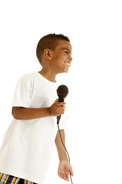 Mały chłopiec śpiewa z mikrofonem Obraz Stockowy