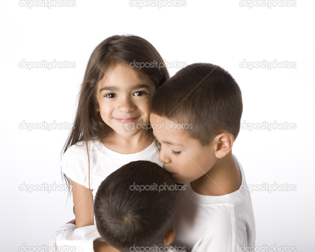 Portrait of hispanic siblings hugging