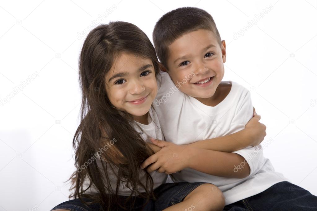 Hispanic siblings hugging