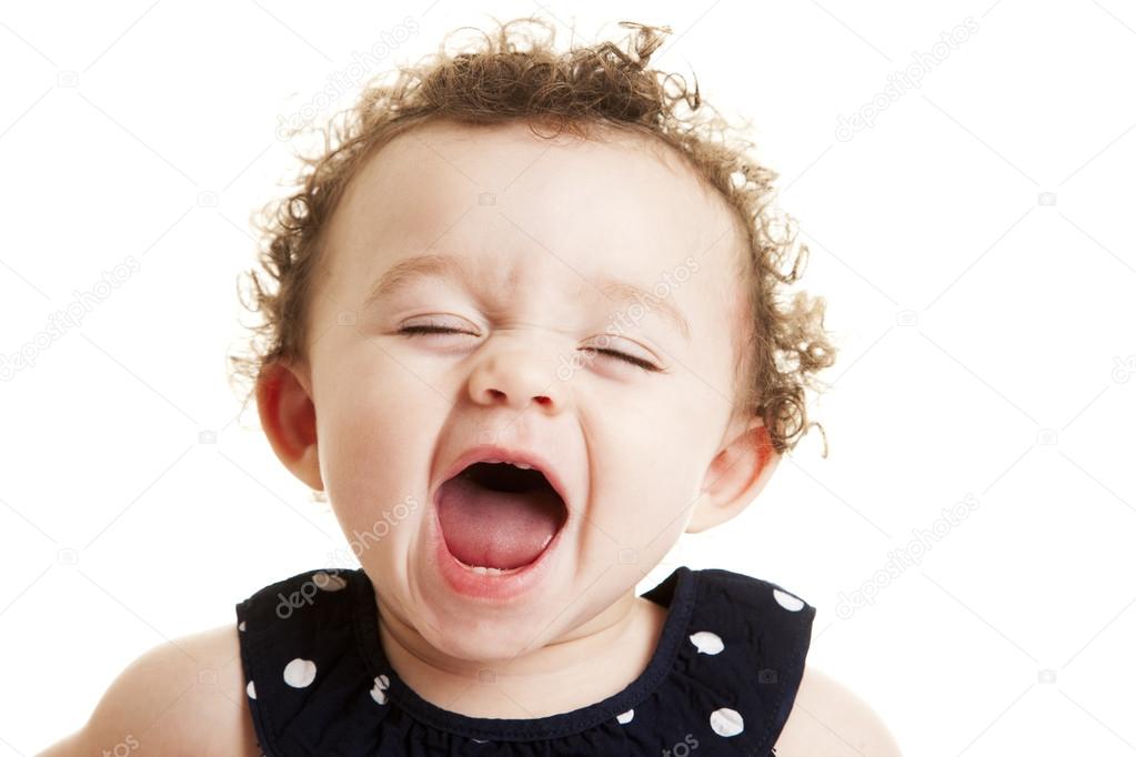 Laughing mixed race baby girl with curly hair