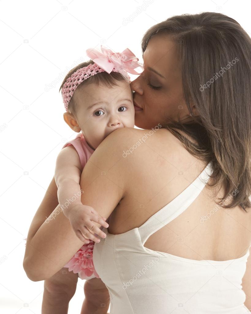 Mother hugging her teething baby daughter