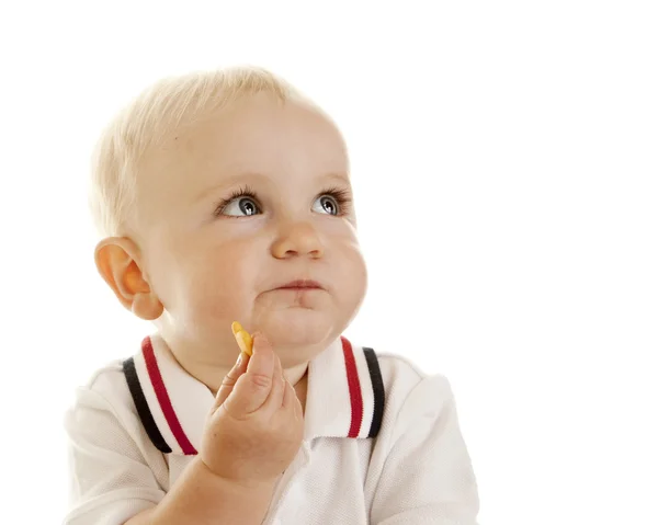 Caucasiano menino comer bolacha — Fotografia de Stock