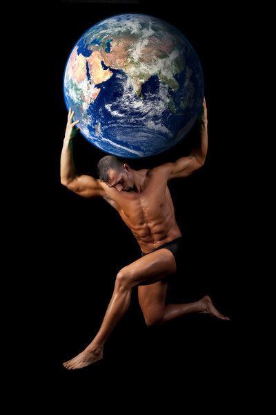 Muscular bodybuilder posing as Atlas with world on shoulders
