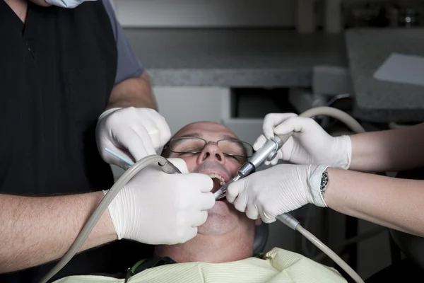 Man getting a tooth filled at the dentist — Stock Photo, Image