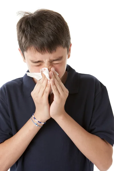 Teen boy is blowing his nose — Stock Photo, Image